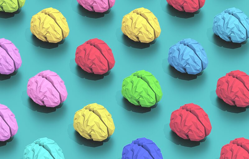 Repeating pattern of multicolored brains on a light blue background.